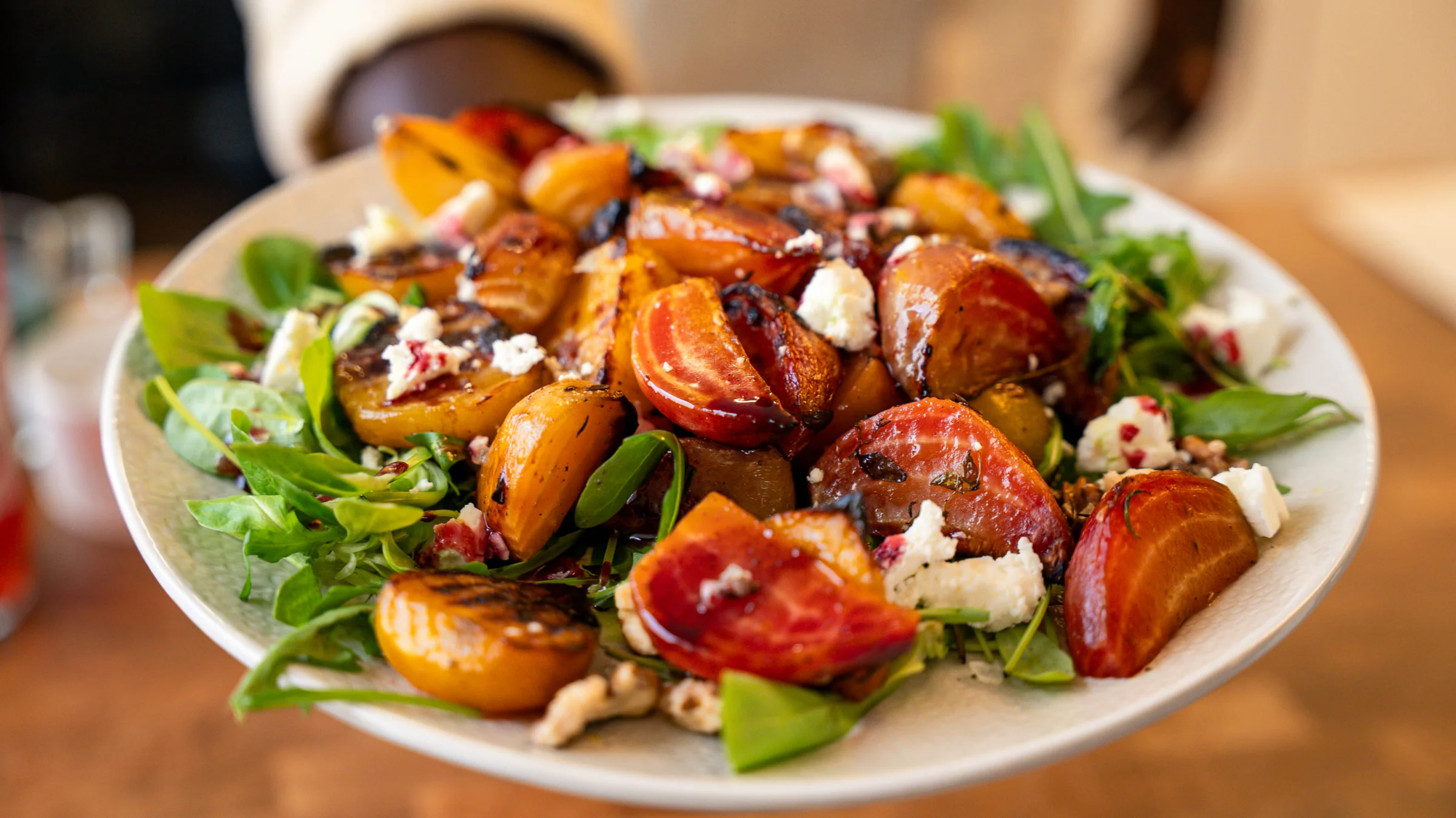 Colorful spring salad with roasted beets and black carrots.