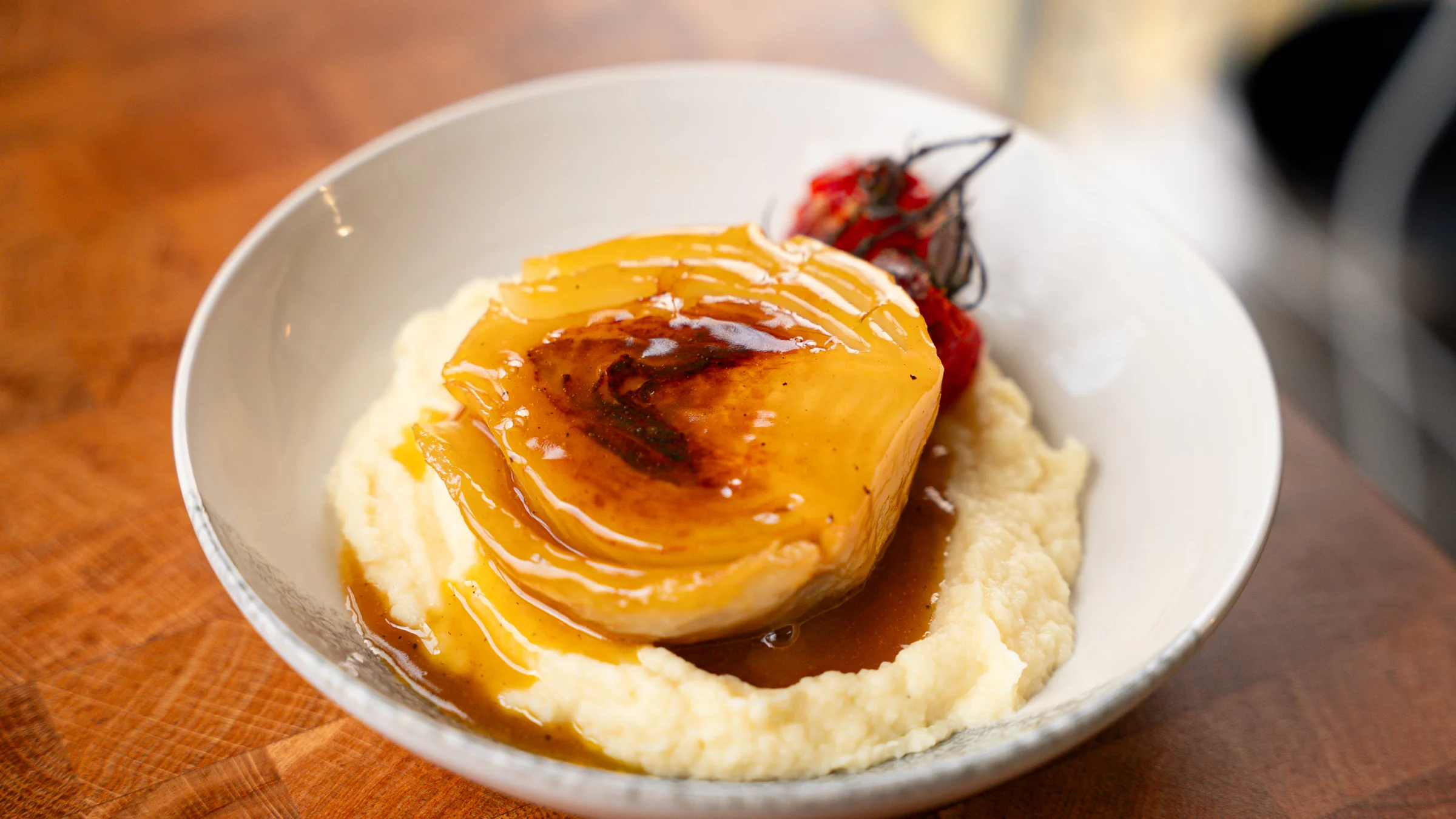 Braised fennel with parsnip purée and roasted cherry tomatoes.