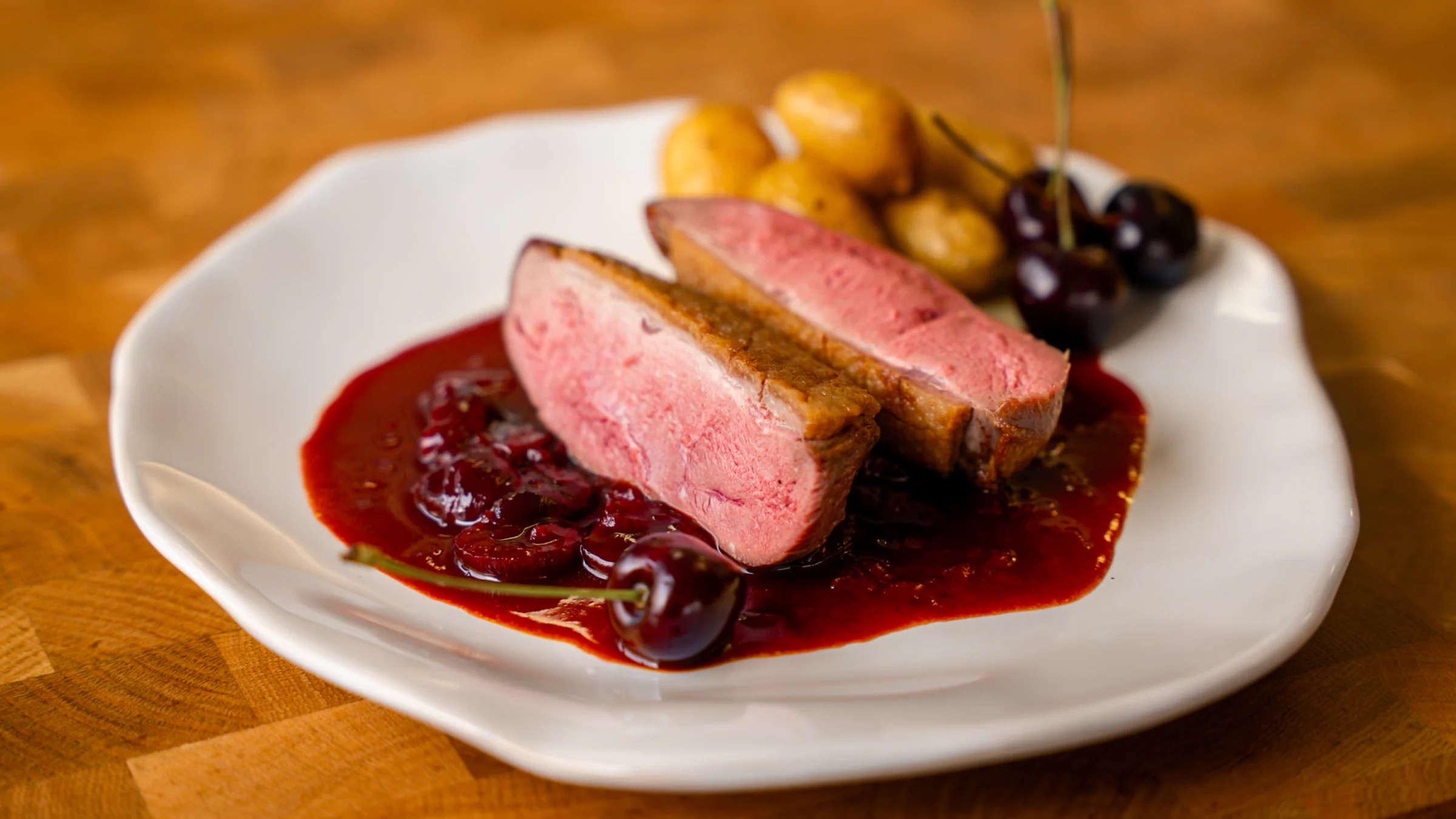 Duck breast with cherry sauce.