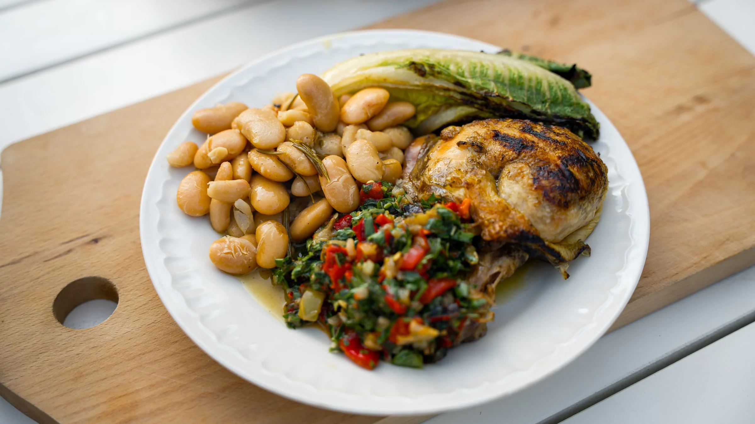 Grilled chicken with buttery beans and herb salsa.