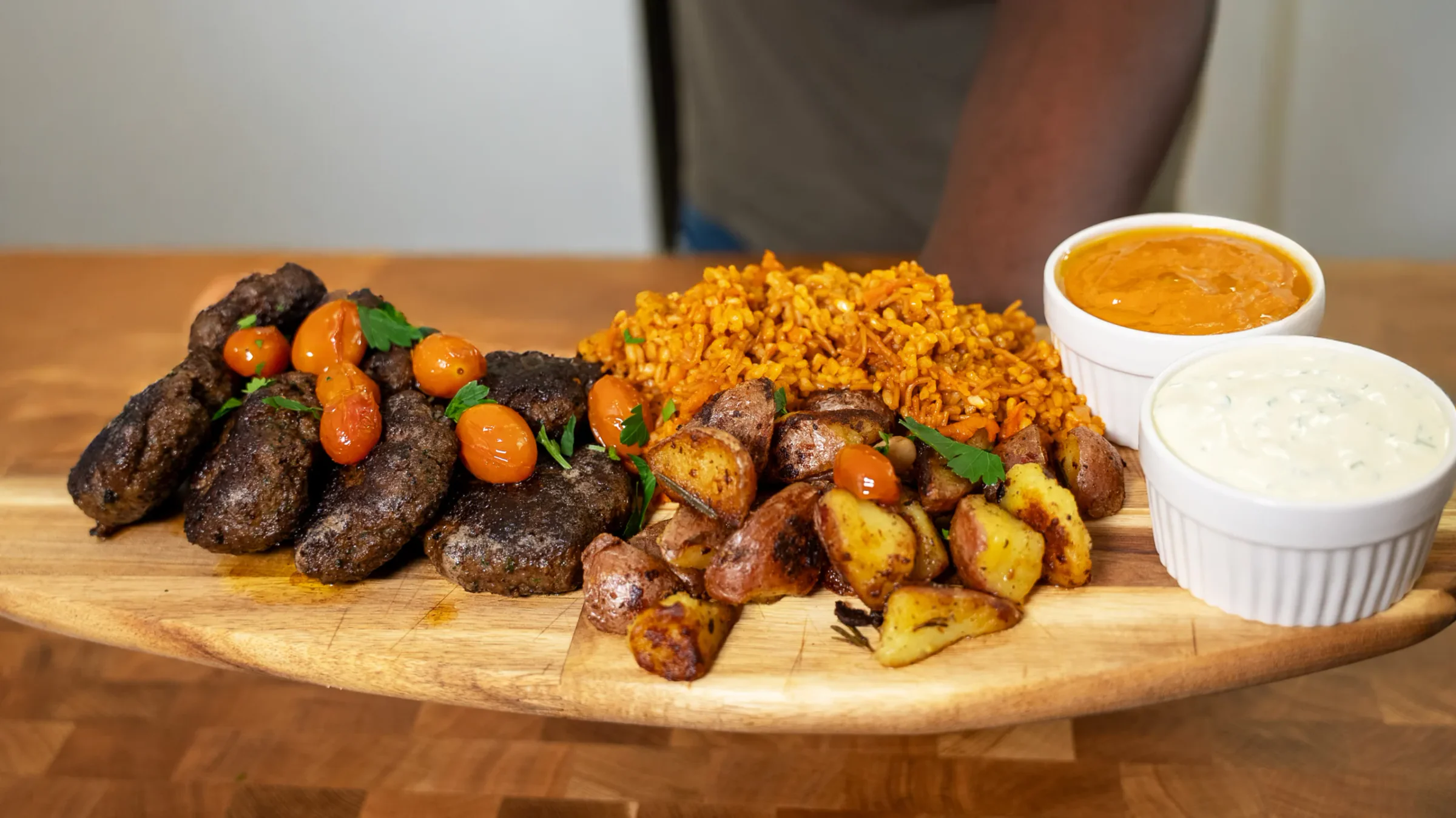 Lamb Patties with Bulgur, Crispy Potatoes & Tomato Confit Sauce.