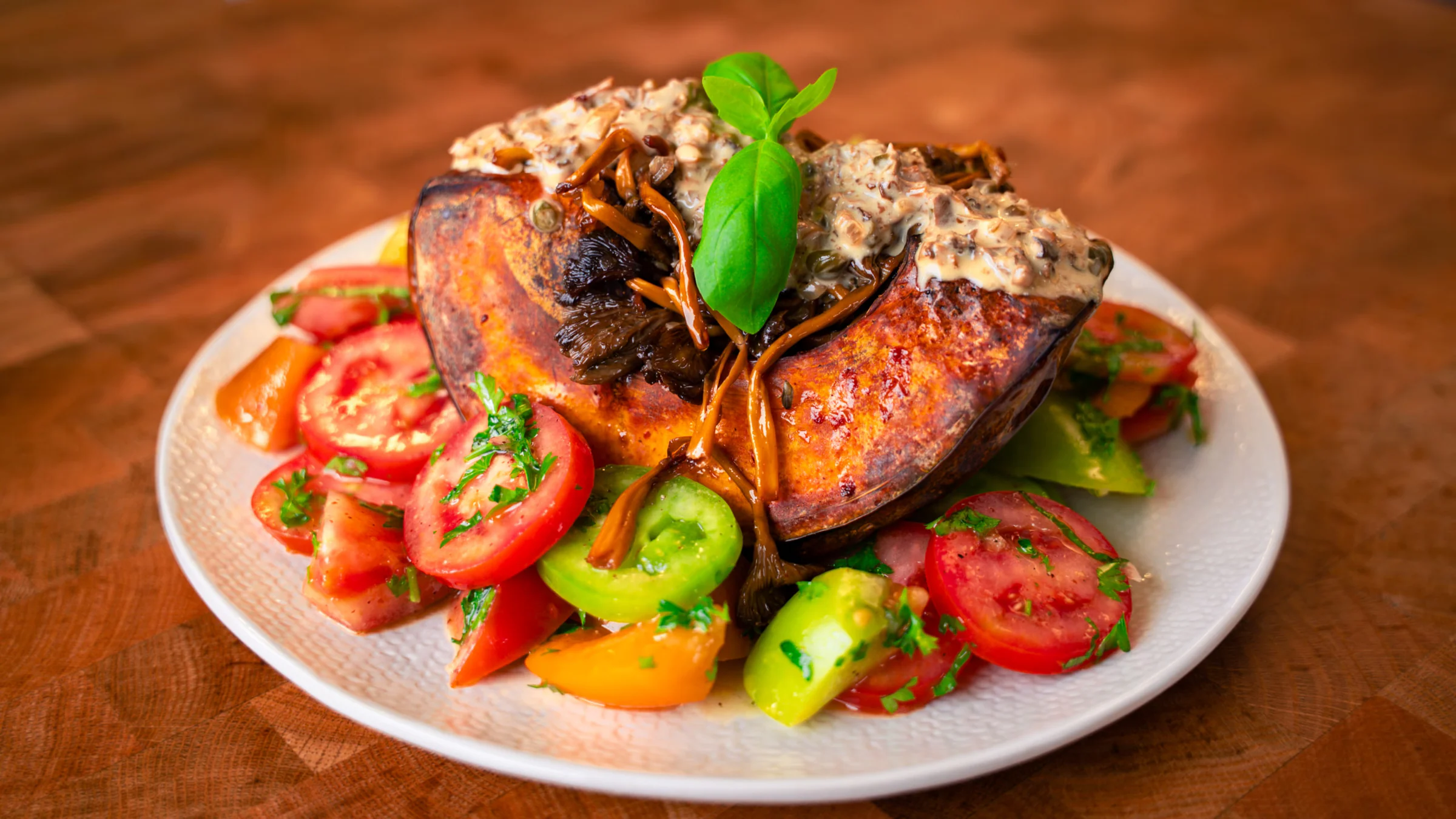 Roasted pumpkin with tomato salad and mushroom sauce.